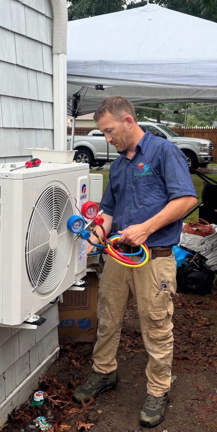 HVAC technician installing a ductless mini-split heat pump in Long Island, NY
